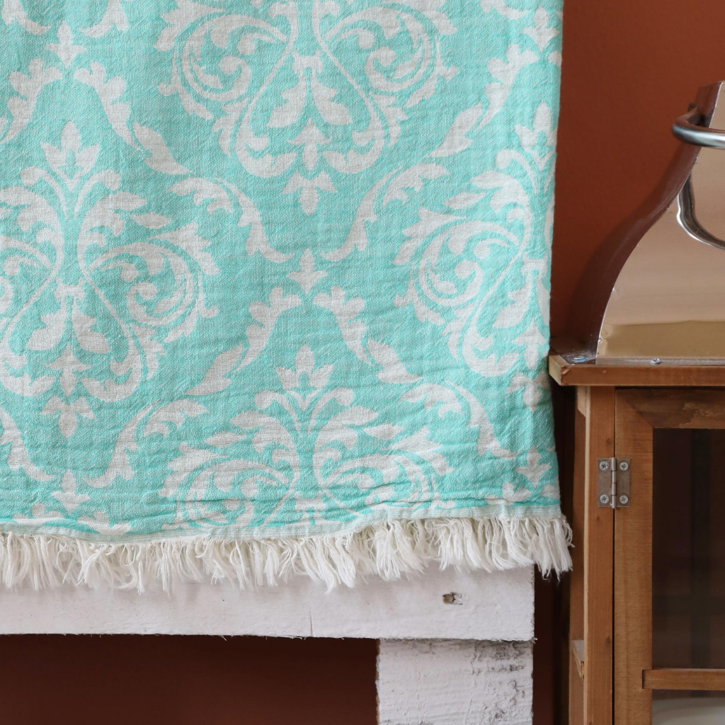 Turquoise, Turkish beach-bath towel has tassels at the edge