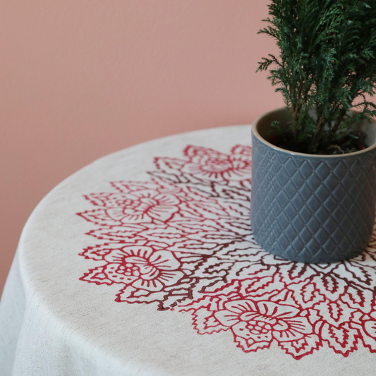 table cloth has hand-made, red, floral prints